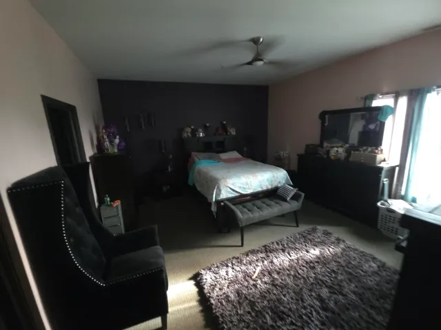 a bed room with furniture and a chandelier