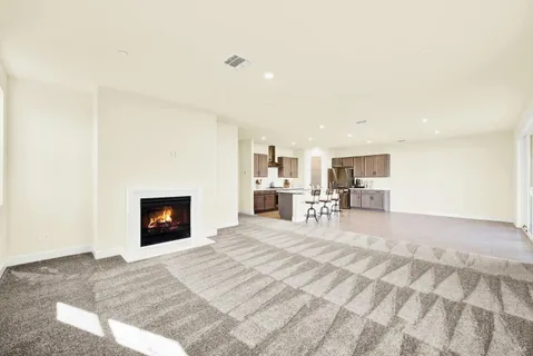 a view of a kitchen with a sink and a fireplace