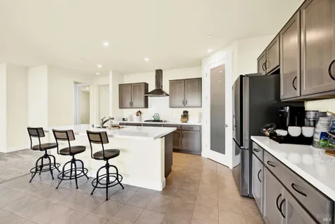 a kitchen with stainless steel appliances kitchen island granite countertop a sink and cabinets