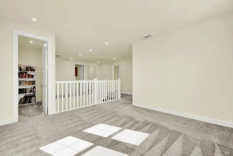 a view of a hallway with seating area
