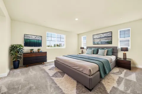 a spacious bedroom with a bed and a flat screen television