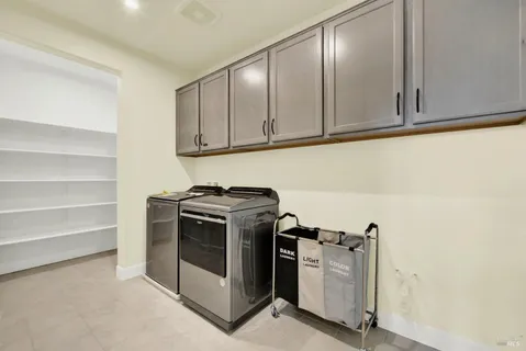 a view of a storage and utility room with washer and dryer