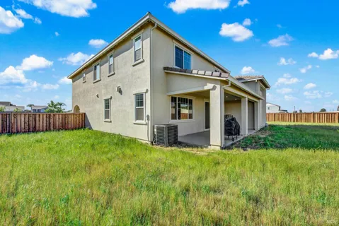 a view of house with backyard