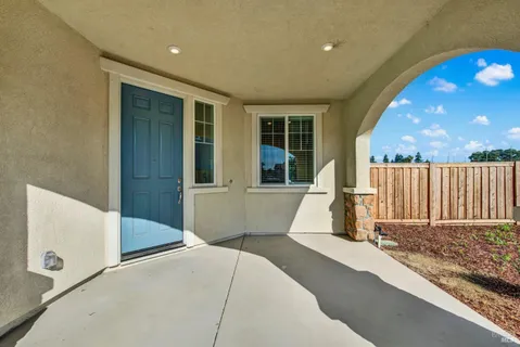 a view of backyard with a small cabin and wooden chair
