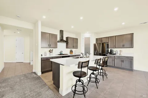 a kitchen with a sink a counter top space stainless steel appliances and cabinets