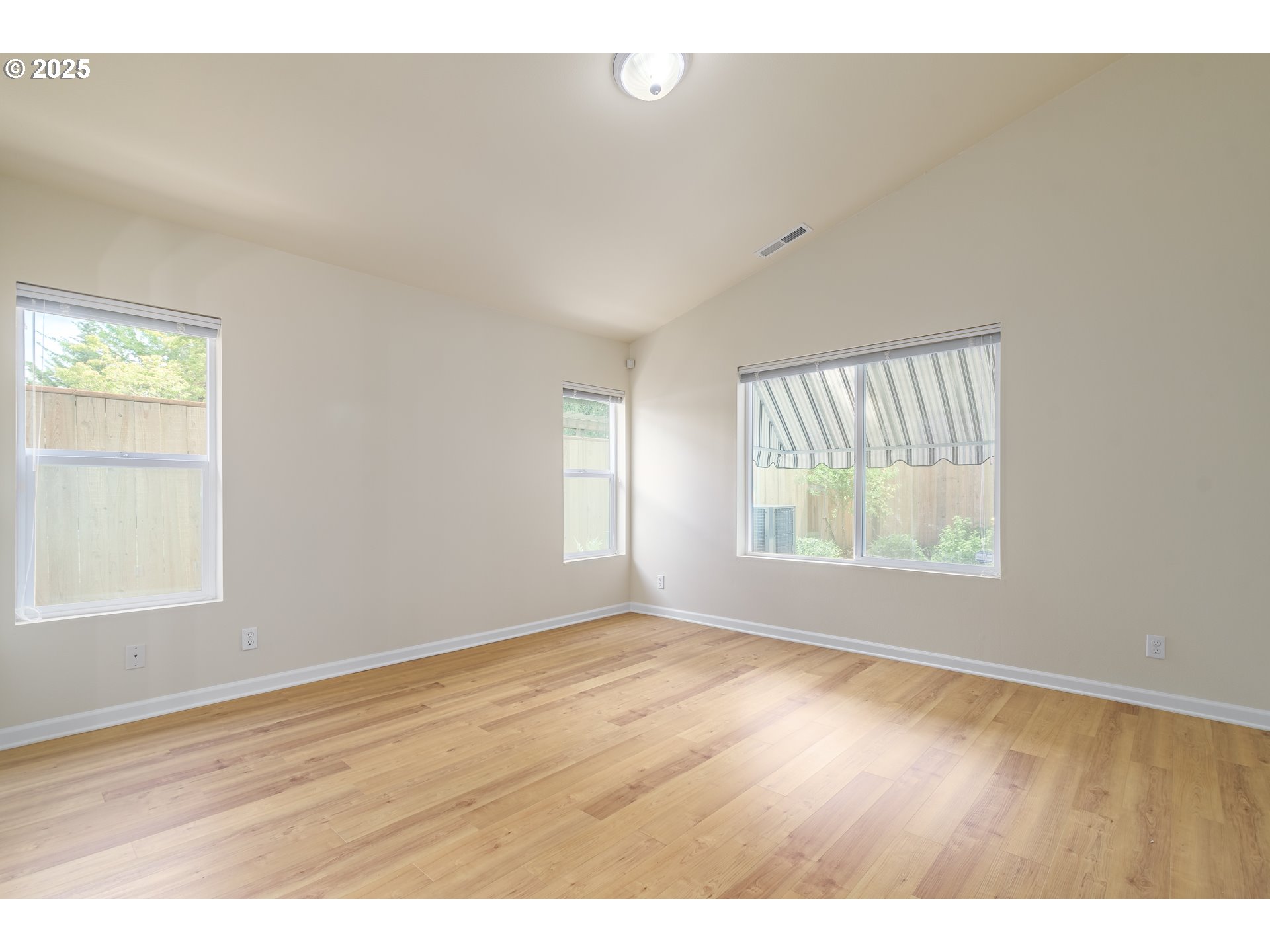 5470 Jeffrey Way Eugene, OR 97402 - Photo 23 of 48 a view of an empty room with wooden floor and a window