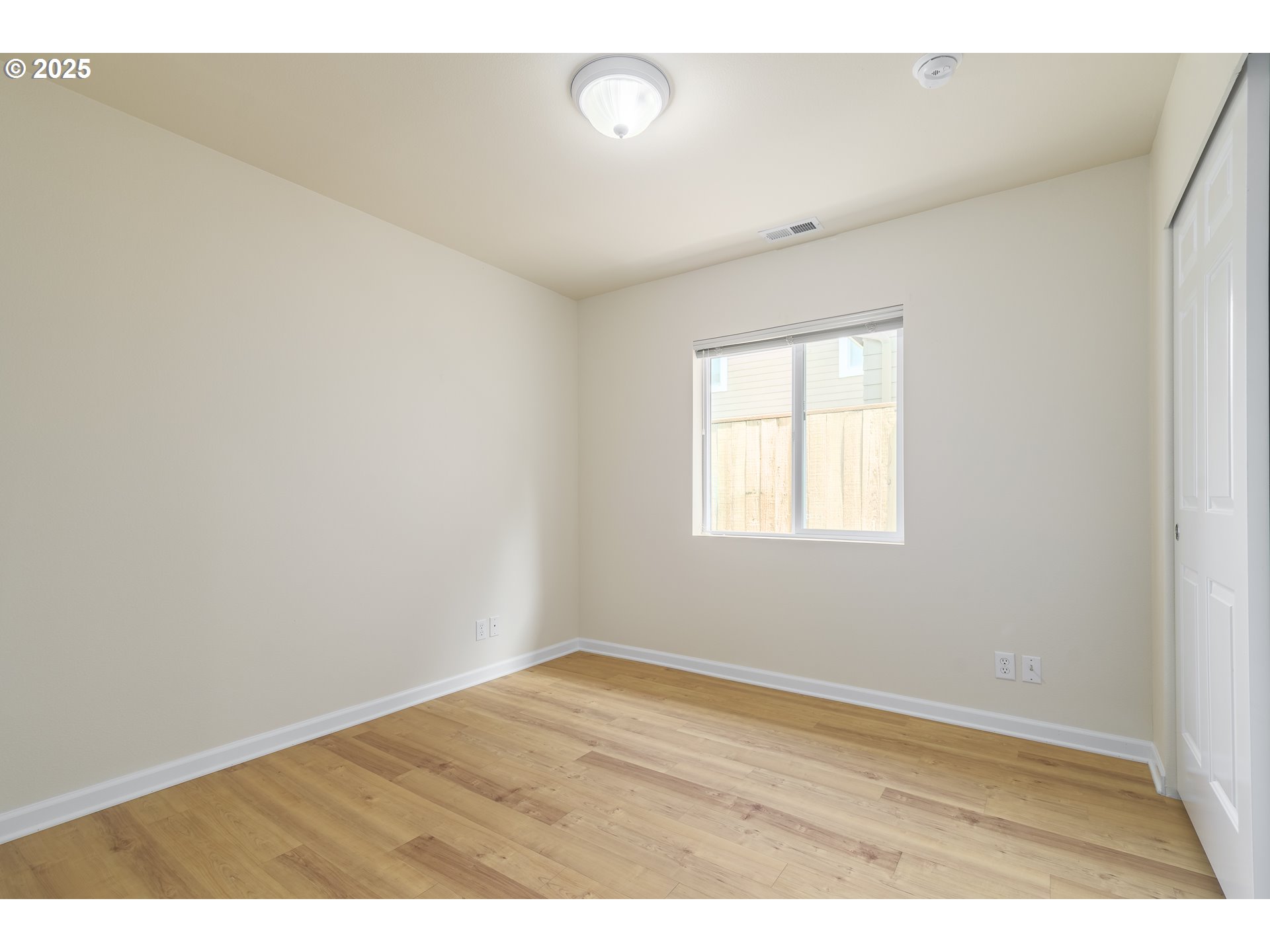 5470 Jeffrey Way Eugene, OR 97402 - Photo 27 of 48 an empty room with wooden floor and windows