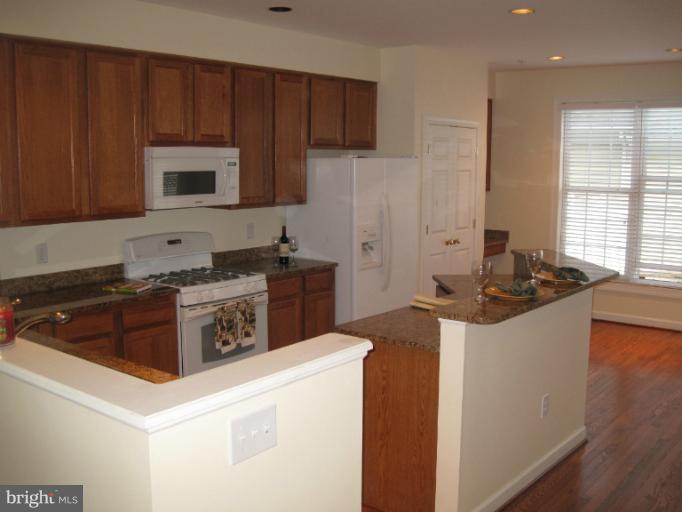 3661 Tavistock Road Frederick, MD 21704 - Photo 8 of 15 a kitchen with a stove and a refrigerator