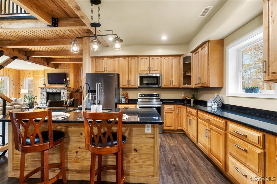 3798 Riddles Bridge Road Goochland, VA 23063 - Photo 11 of 31 a kitchen with stainless steel appliances granite countertop a stove top oven a sink dishwasher a dining table and chairs with wooden floor