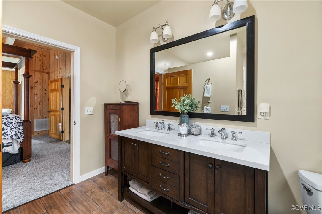 3798 Riddles Bridge Road Goochland, VA 23063 - Photo 18 of 31 a en suite bathroom with a double vanity sink and a mirror