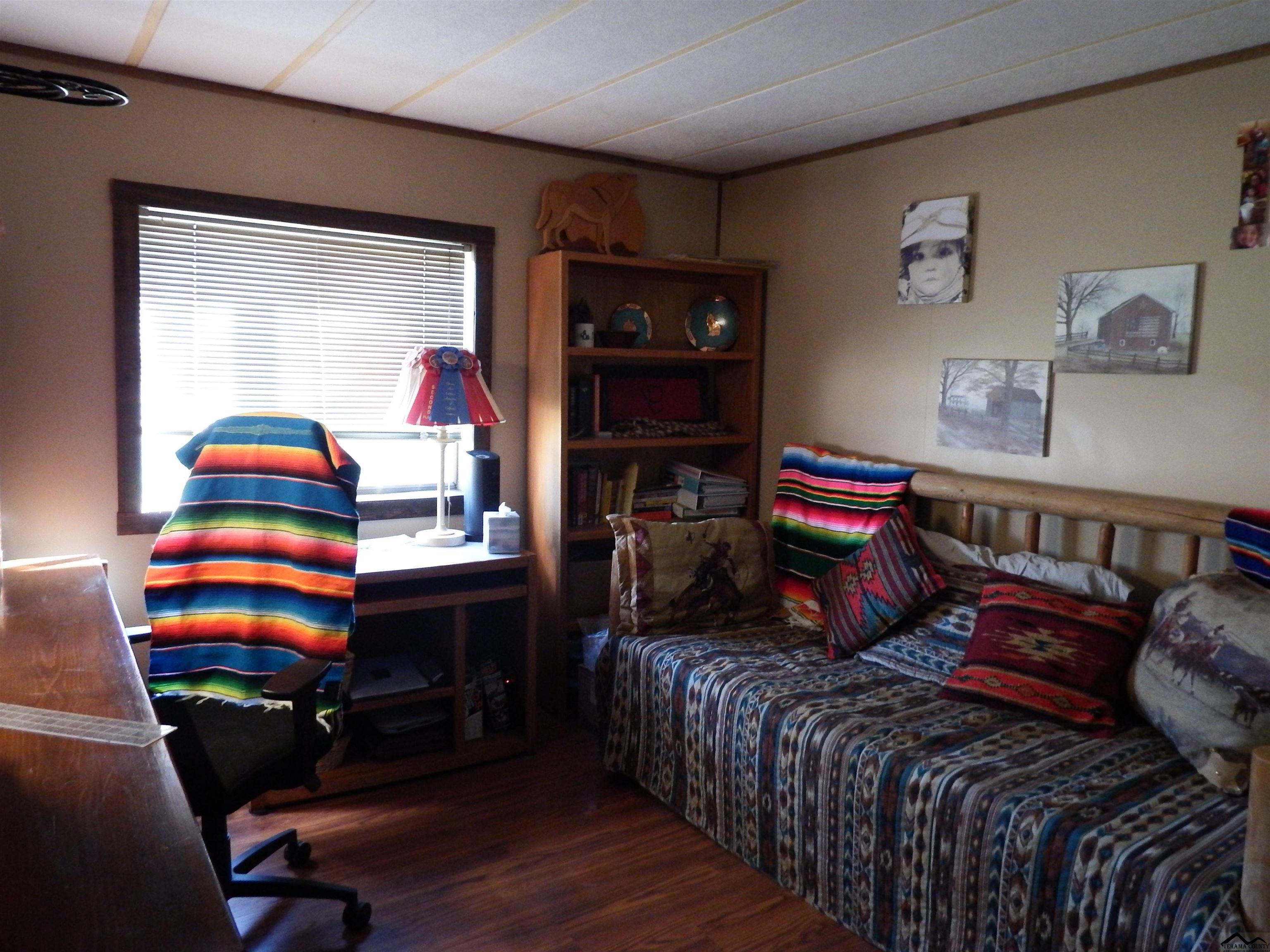 12535 Wilder Road Red Bluff, CA 96080 - Photo 13 of 30 a bedroom with a bed and wooden floor