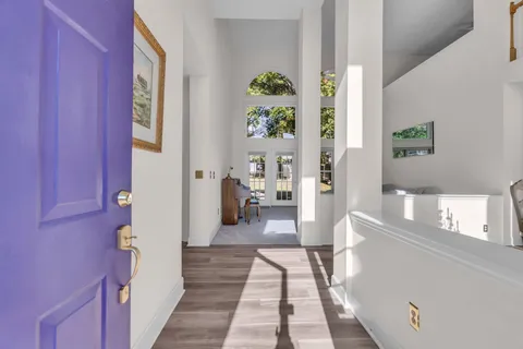 a hallway with painting and wooden floor