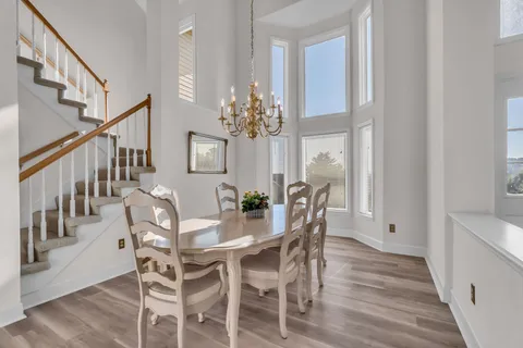 a view of a dining room with furniture and wooden floor
