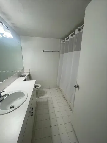 a bathroom with a sink shower and a mirror