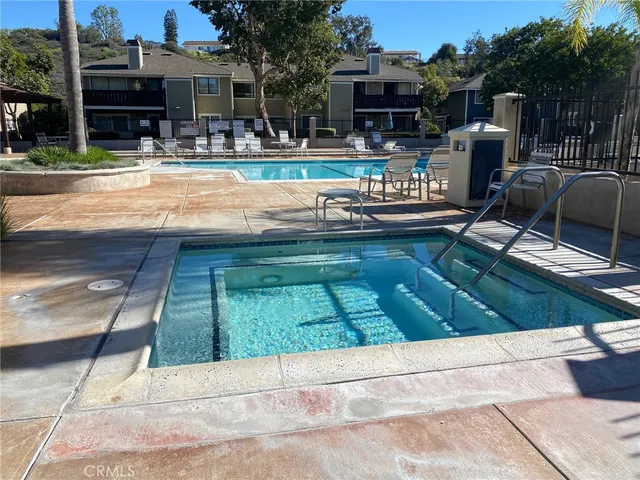 a view of swimming pool with chairs and tables