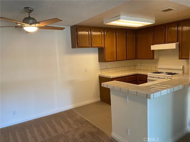 a kitchen with a sink a stove and a window