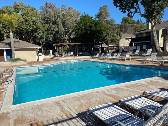 a view of a swimming pool with outdoor seating