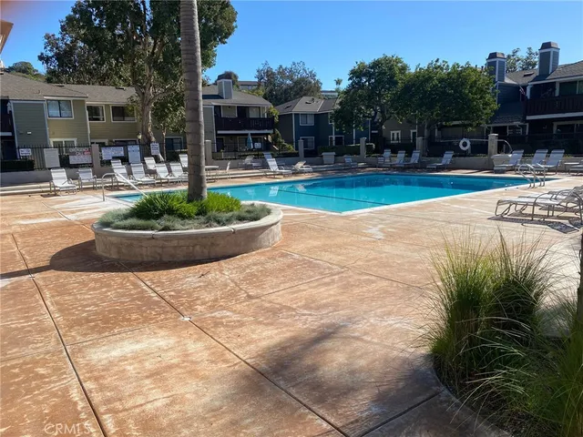 a swimming pool with outdoor seating and yard
