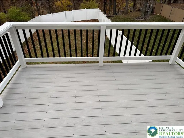 a view of wooden fence and trees