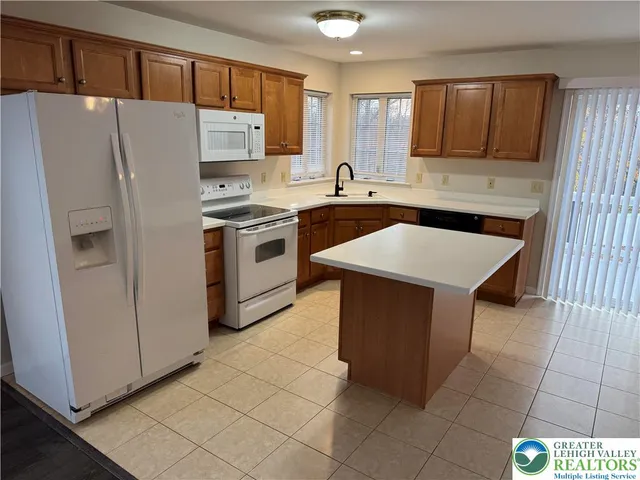 a kitchen with stainless steel appliances a refrigerator sink and cabinets
