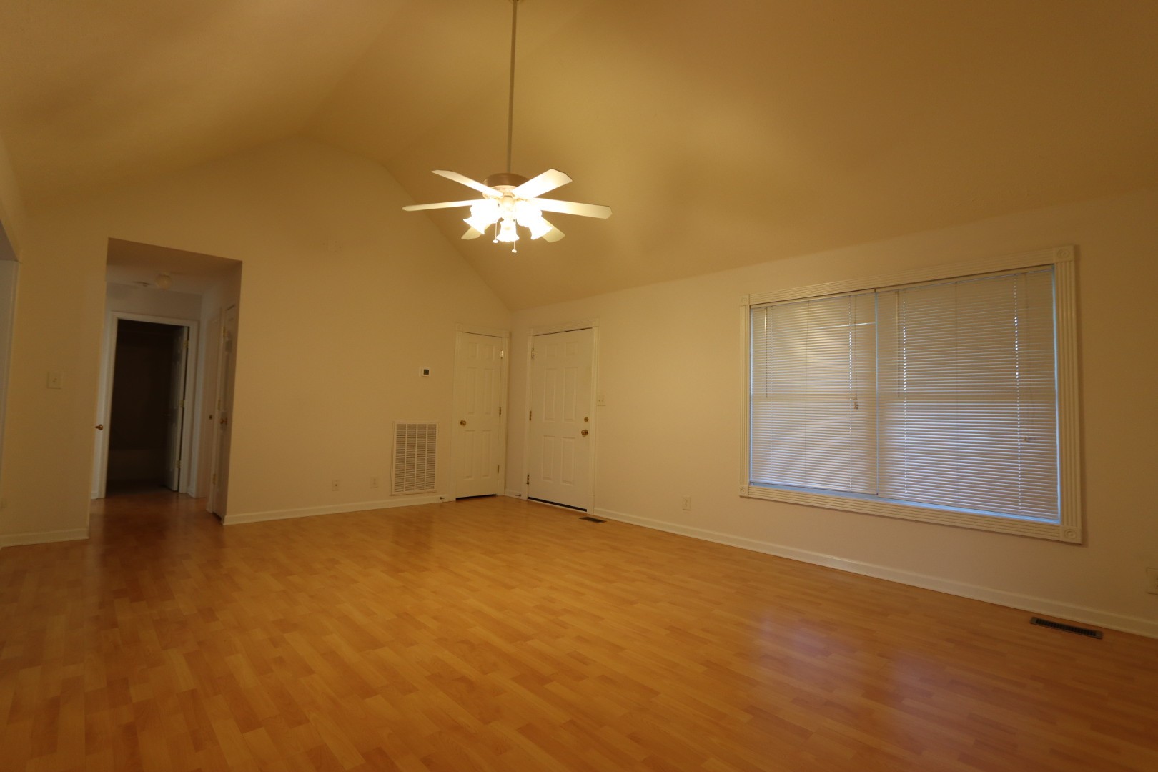 1462 Lock B Road South Clarksville, TN 37040 - Photo 3 of 25 an empty room with windows and chandelier fan
