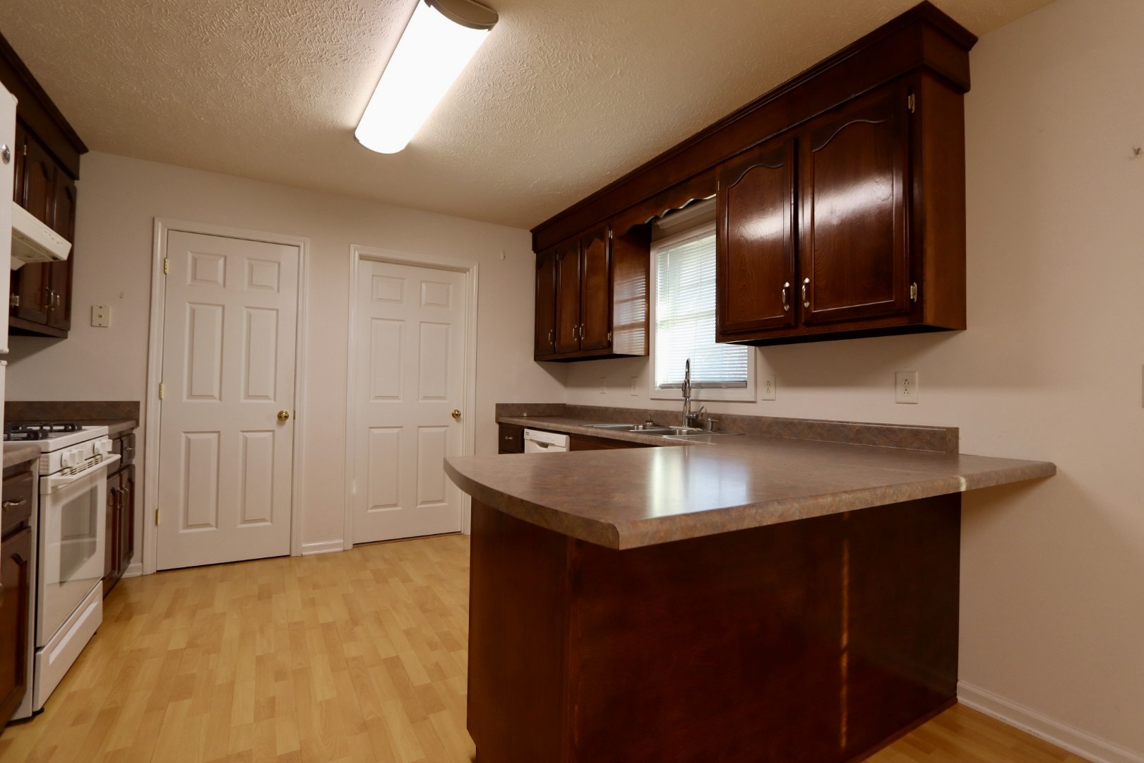 1462 Lock B Road South Clarksville, TN 37040 - Photo 9 of 25 a kitchen with granite countertop stainless steel appliances a sink stove and refrigerator