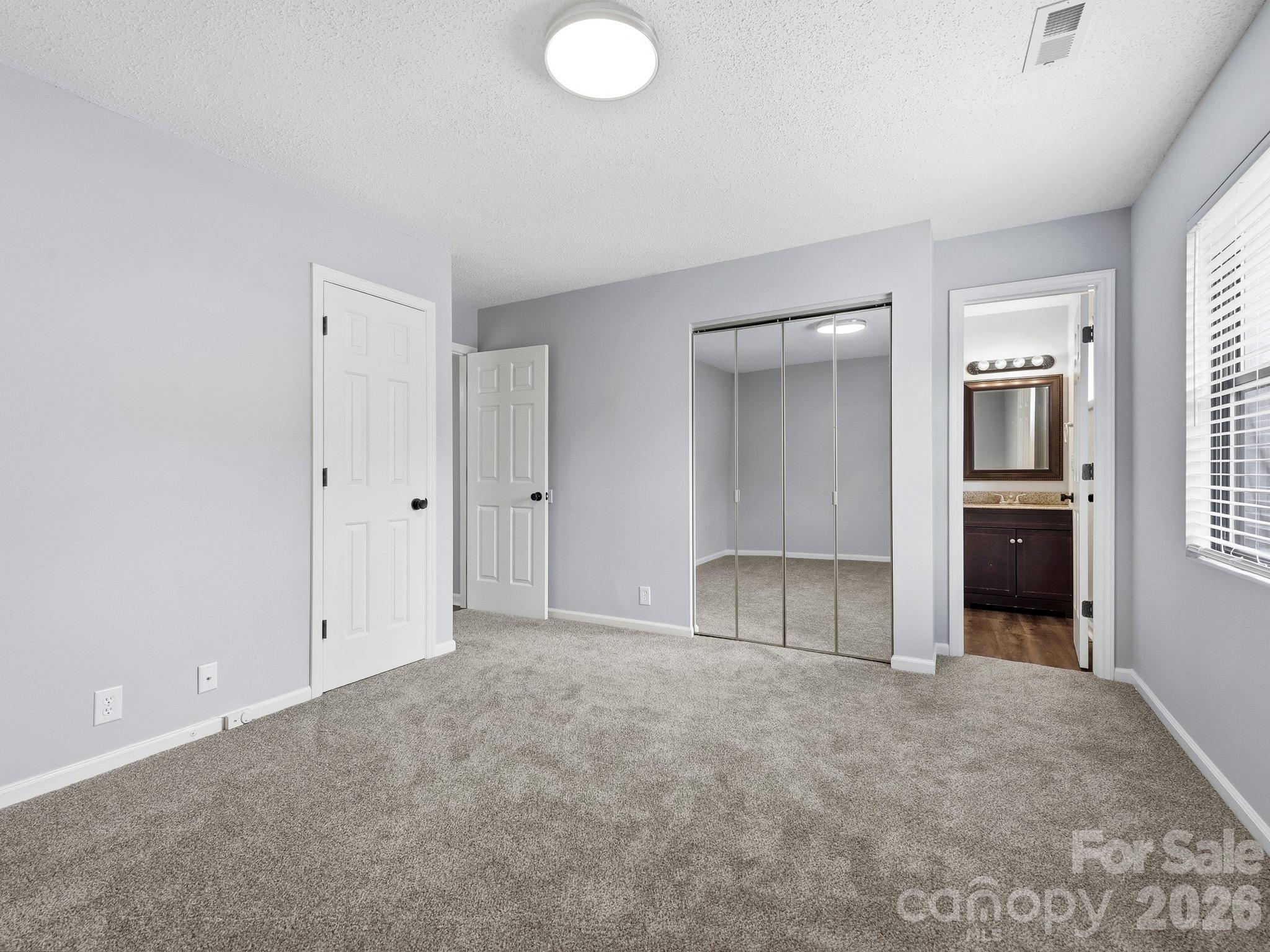 110 Heywood Road Arden, NC 28704 - Photo 12 of 22 a view of an empty room with kitchen and a window