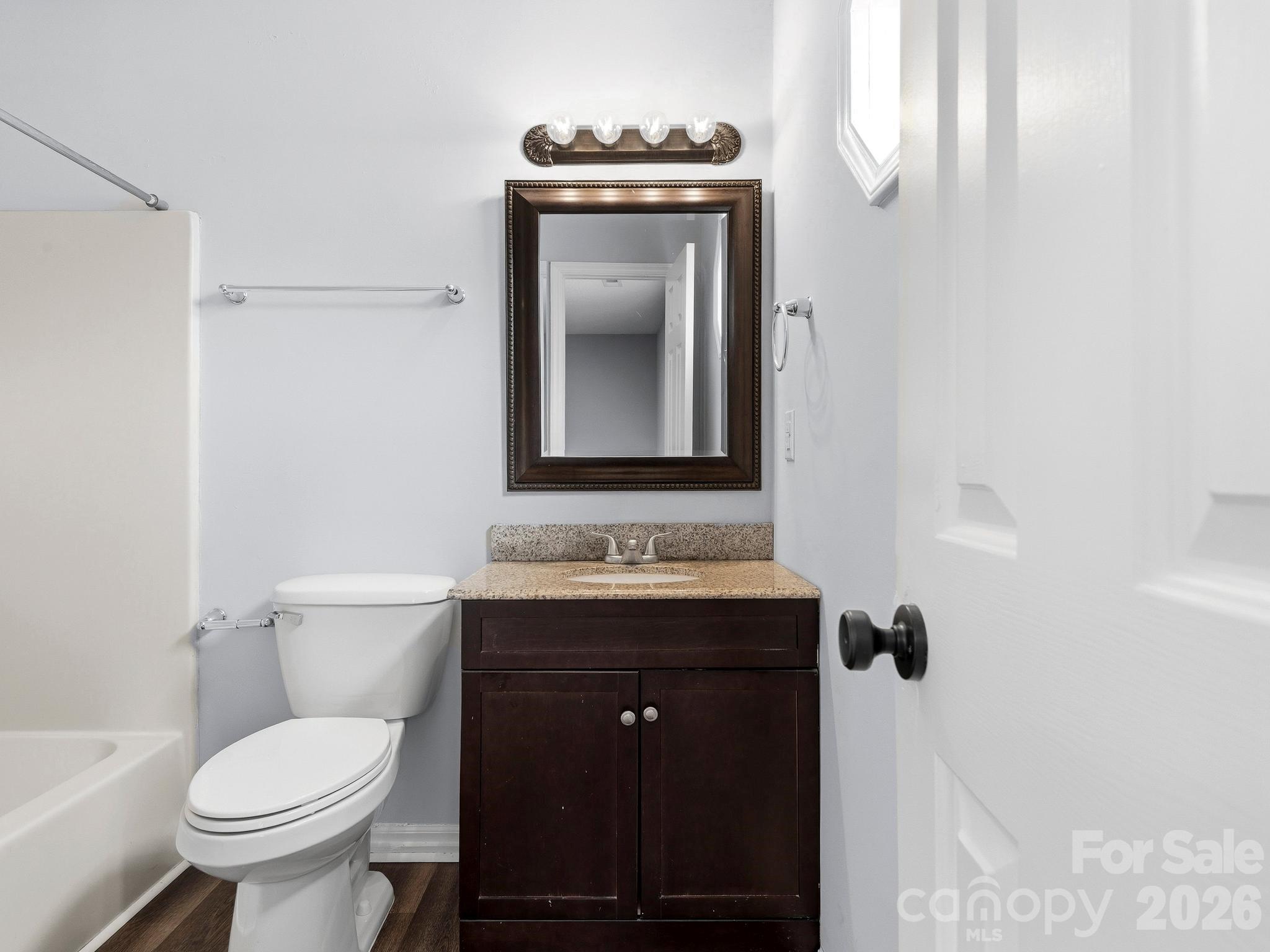 110 Heywood Road Arden, NC 28704 - Photo 13 of 22 a bathroom with a toilet sink and mirror