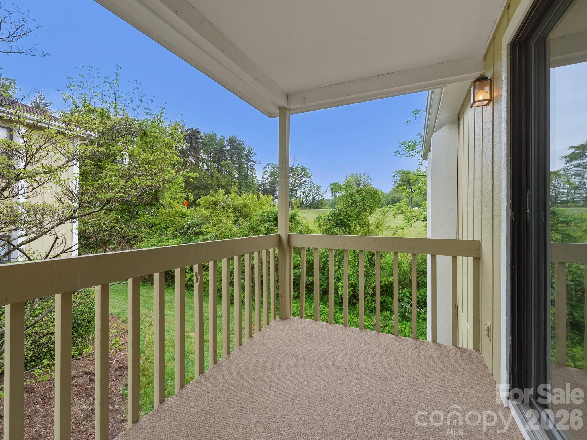 110 Heywood Road Arden, NC 28704 - Photo 20 of 22 a view of a balcony with wooden floor