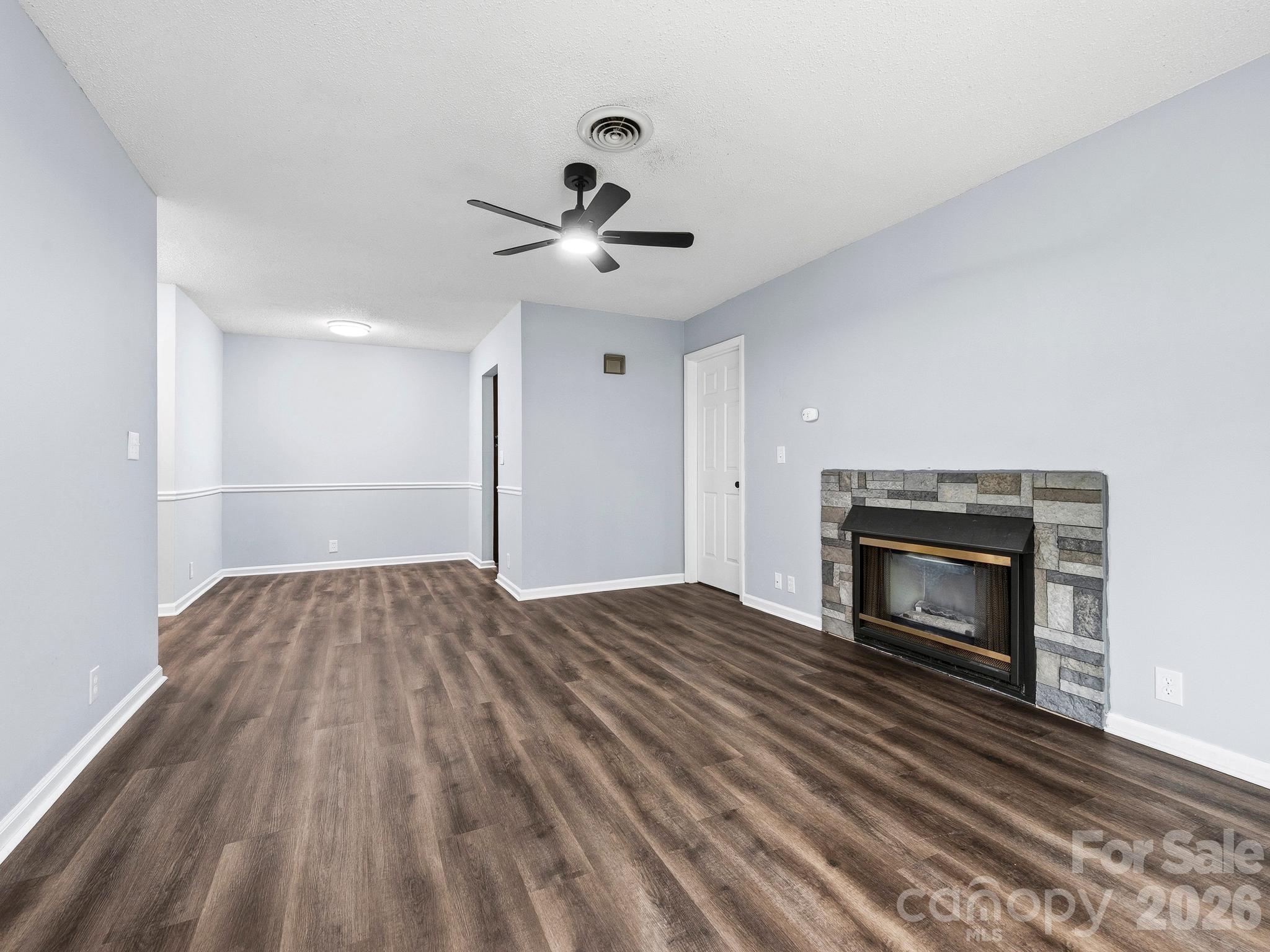110 Heywood Road Arden, NC 28704 - Photo 4 of 22 a view of empty room with wooden floor and fireplace