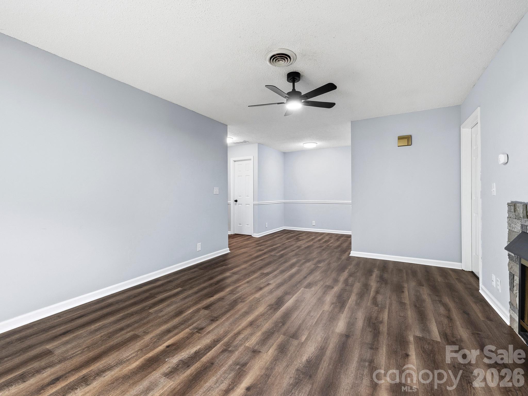110 Heywood Road Arden, NC 28704 - Photo 5 of 22 a view of empty room with wooden floor and fan
