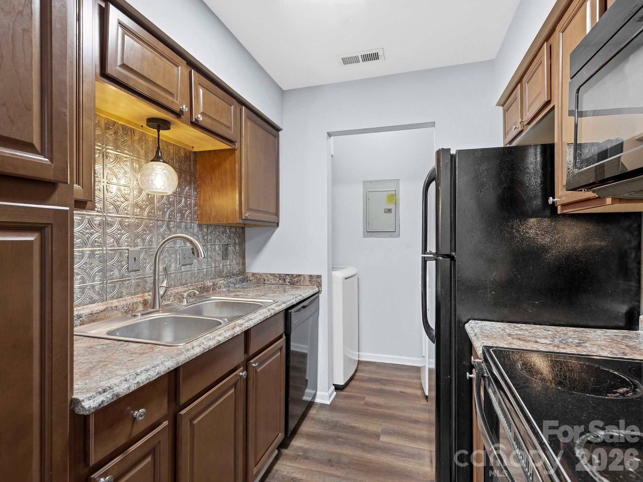 110 Heywood Road Arden, NC 28704 - Photo 6 of 22 a kitchen with stainless steel appliances granite countertop a refrigerator and a sink