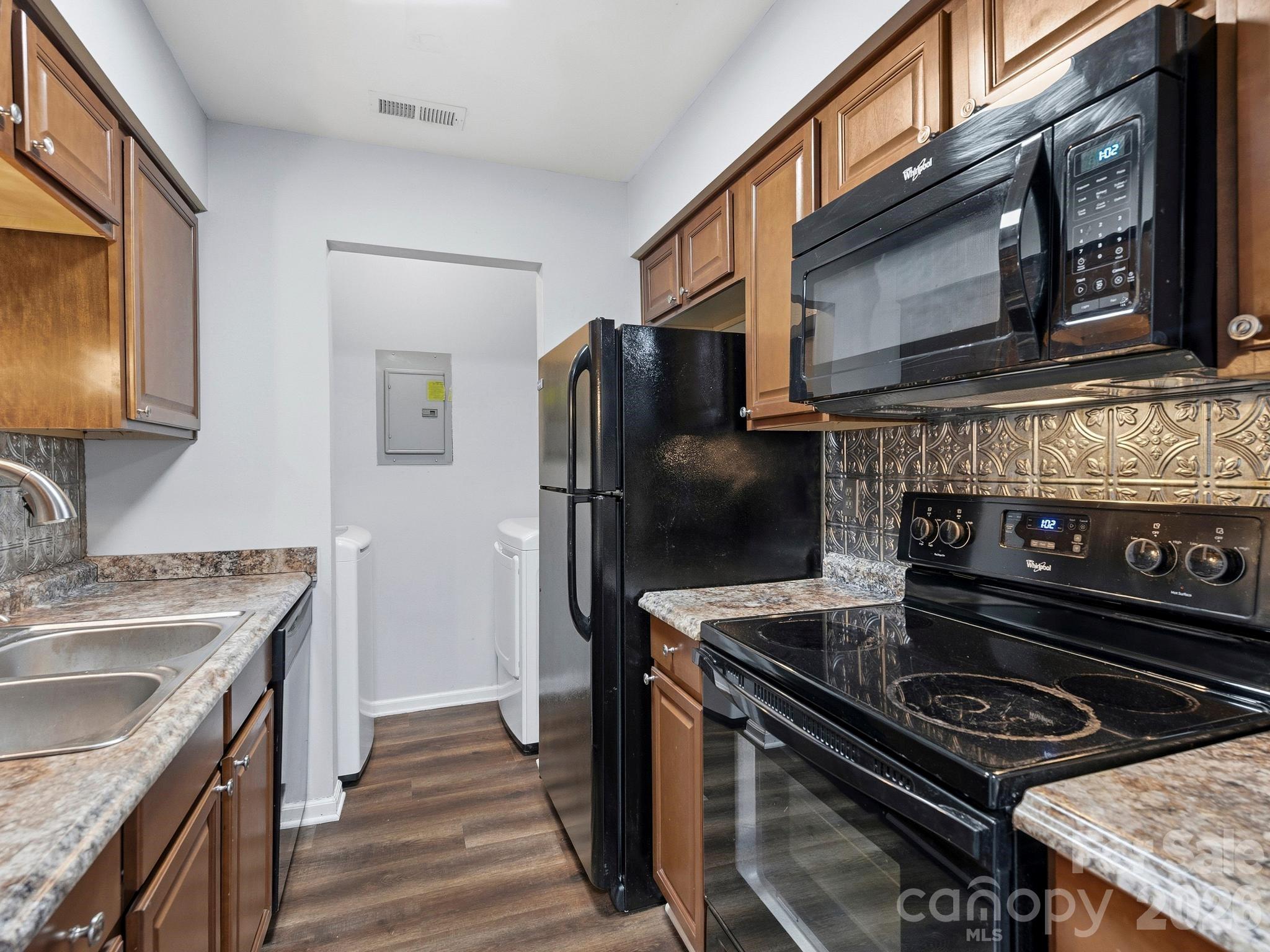 110 Heywood Road Arden, NC 28704 - Photo 8 of 22 a kitchen with a stove and a microwave