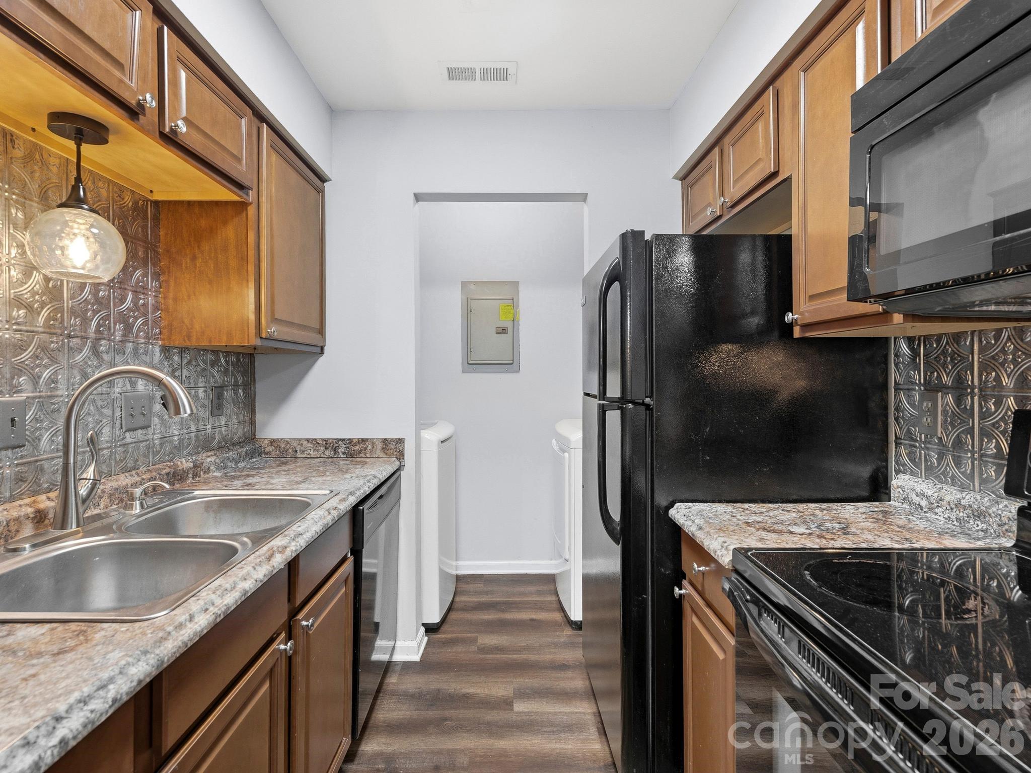 110 Heywood Road Arden, NC 28704 - Photo 9 of 22 a kitchen with granite countertop a sink stove and refrigerator