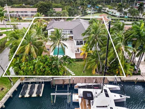 an aerial view of house with yard swimming pool and outdoor seating