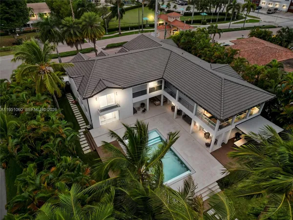an aerial view of a house with a yard and potted plants