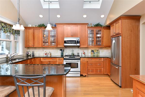 38 Jenness Street Quincy, MA 02169 - Photo 12 of 23 a kitchen with stainless steel appliances granite countertop a refrigerator a stove and a sink