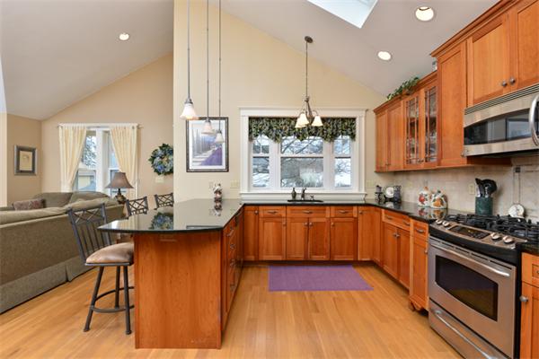 38 Jenness Street Quincy, MA 02169 - Photo 13 of 23 a kitchen with stainless steel appliances granite countertop a stove a sink and a wooden cabinets