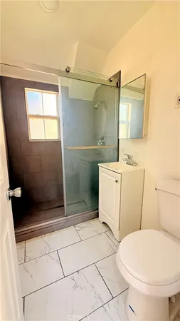 a bathroom with a sink a toilet a mirror and vanity