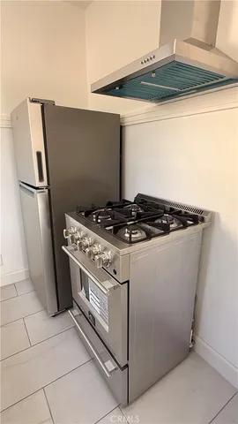 a white refrigerator freezer and a stove sitting inside of a kitchen