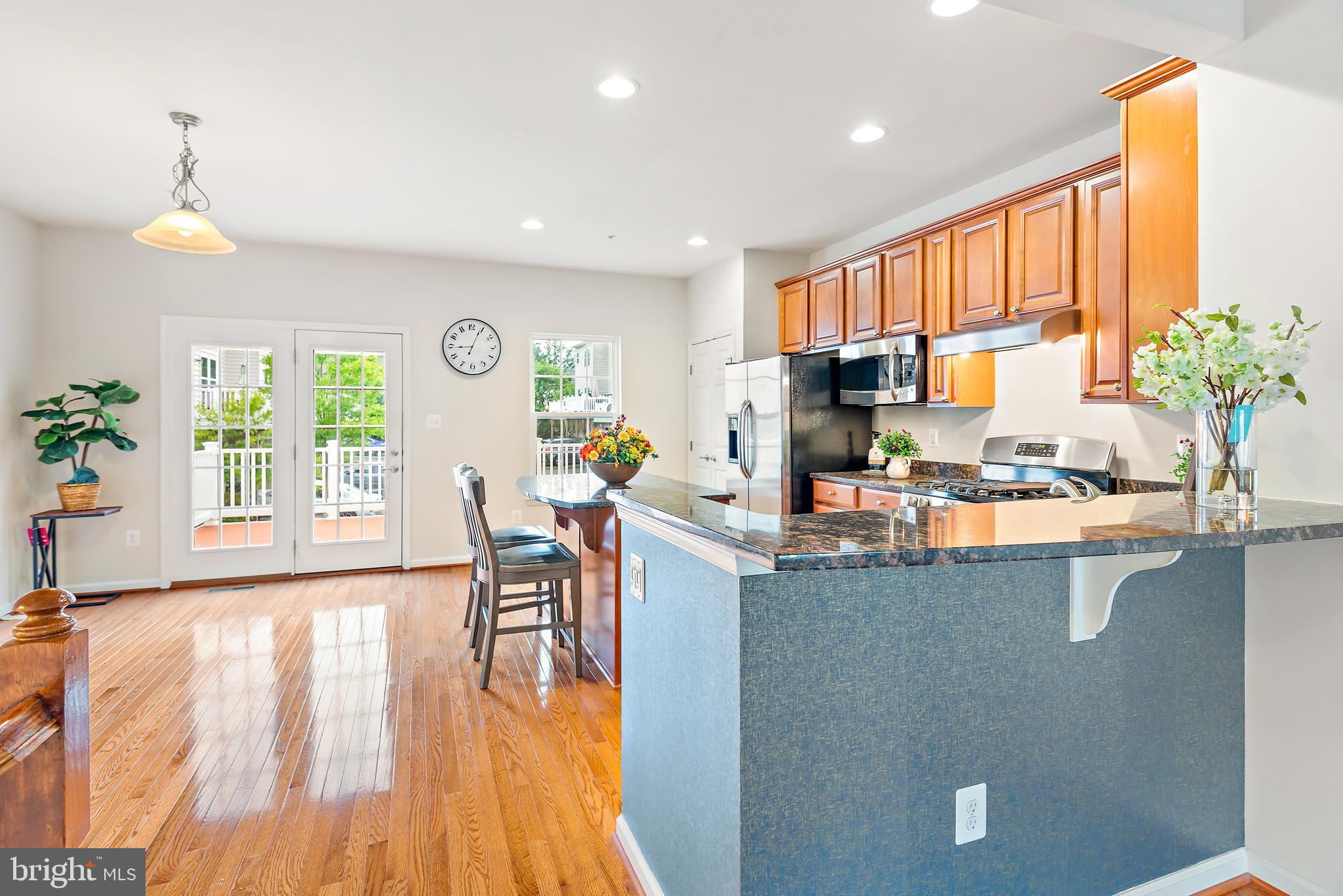 3838 Cullingworth Road Burtonsville, MD 20866 - Photo 27 of 69 a kitchen with granite countertop a stove and a wooden floors