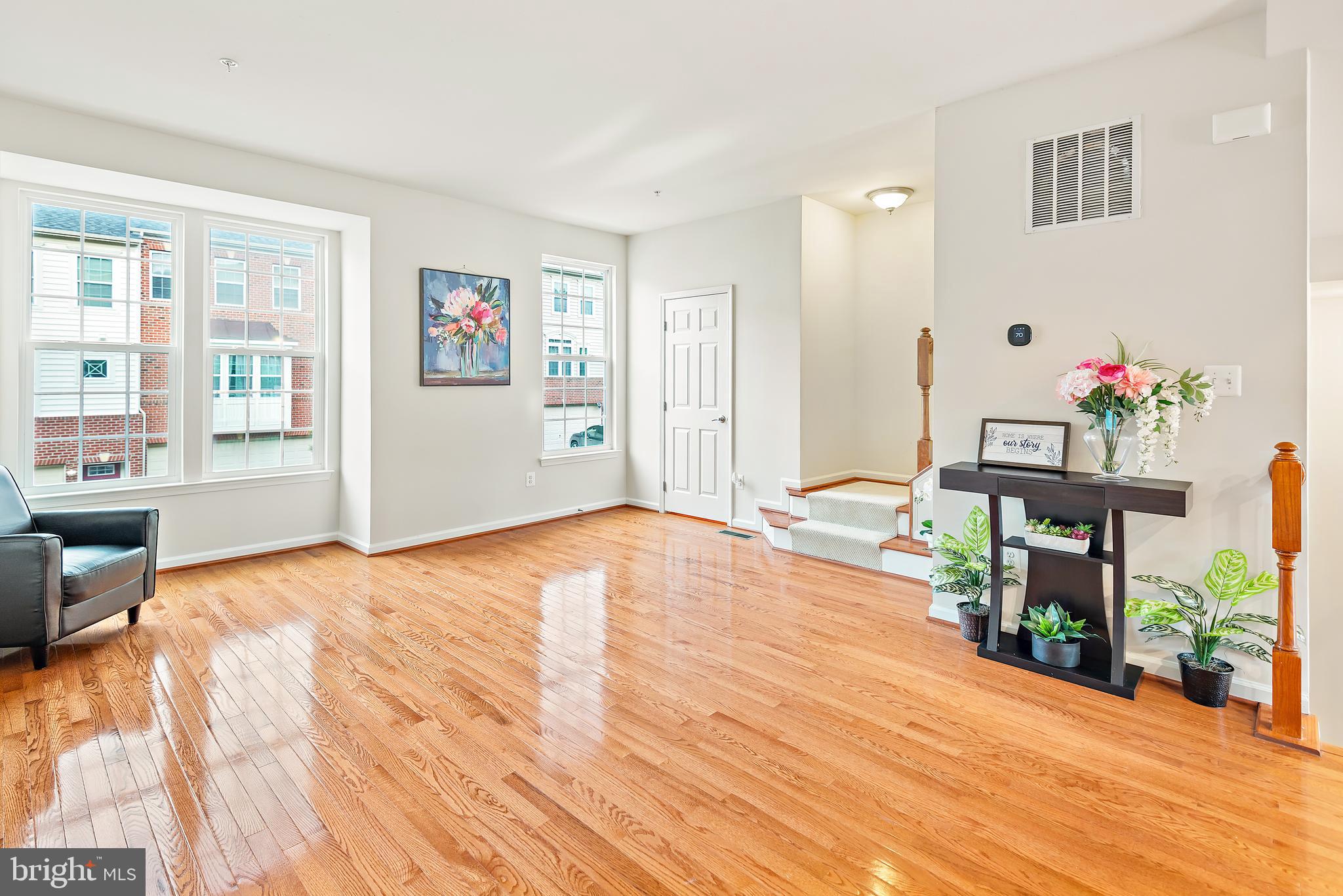 3838 Cullingworth Road Burtonsville, MD 20866 - Photo 43 of 69 a view of an empty room with wooden floor and a window
