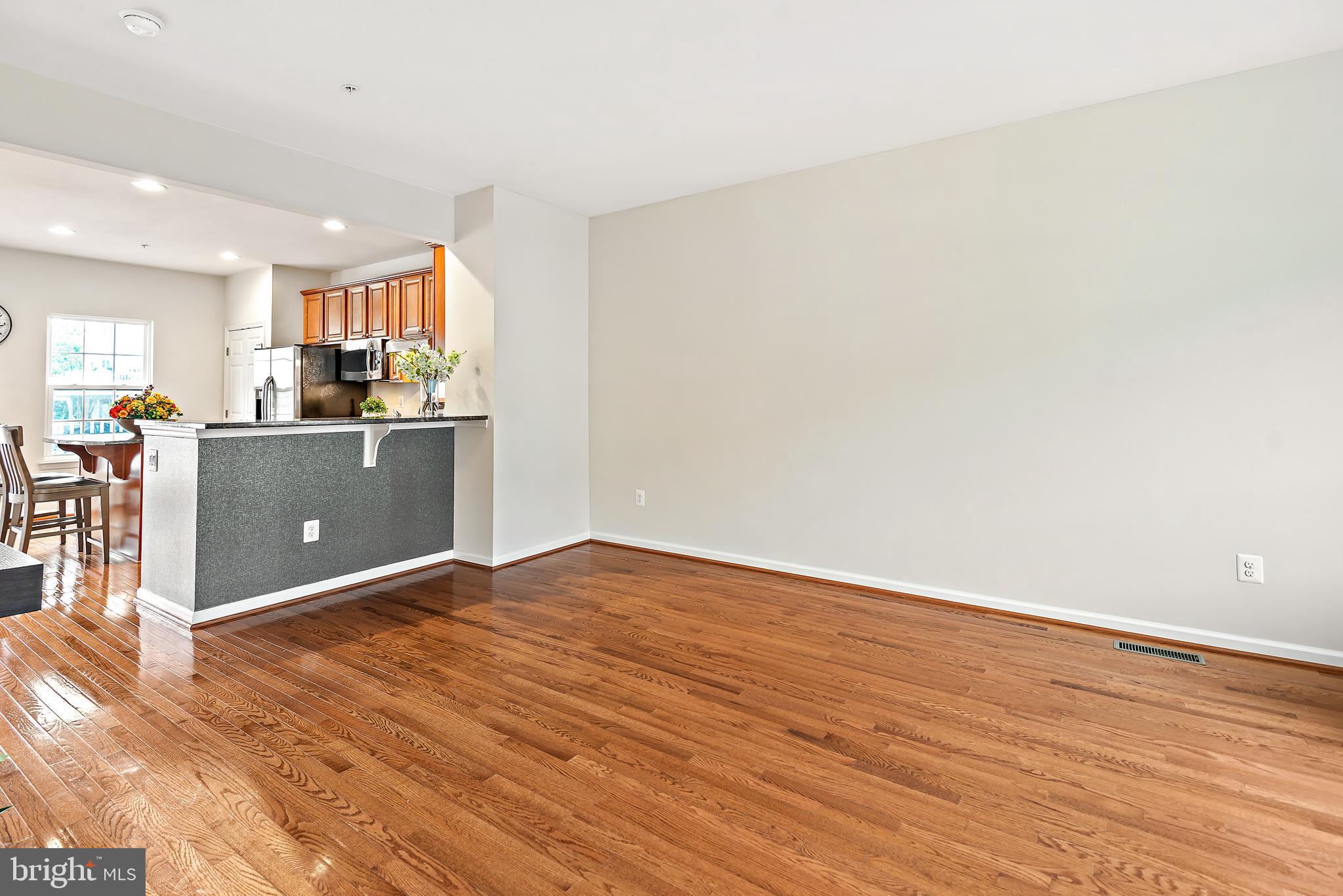 3838 Cullingworth Road Burtonsville, MD 20866 - Photo 52 of 69 a view of kitchen and empty room with wooden floor