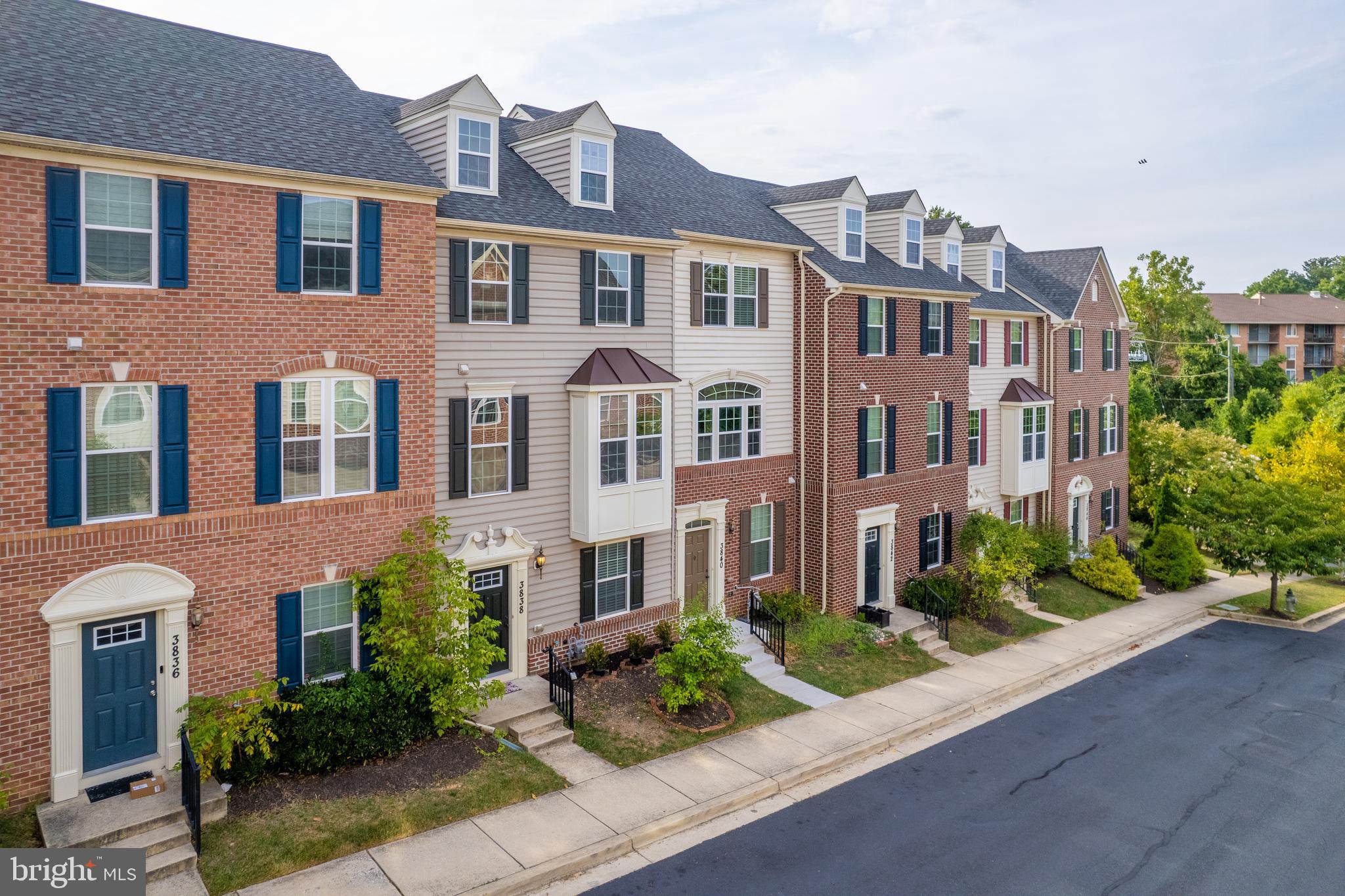 3838 Cullingworth Road Burtonsville, MD 20866 - Photo 8 of 69 a front view of a multi story residential apartment building with yard and green space