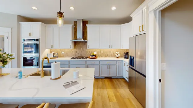 a kitchen with cabinets and wooden floor