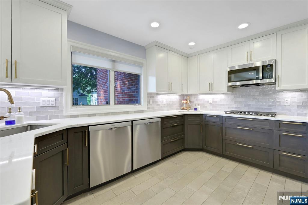 514 Rutland Avenue Teaneck, NJ 07666 - Photo 11 of 40 a kitchen with stainless steel appliances granite countertop a sink and stove top oven