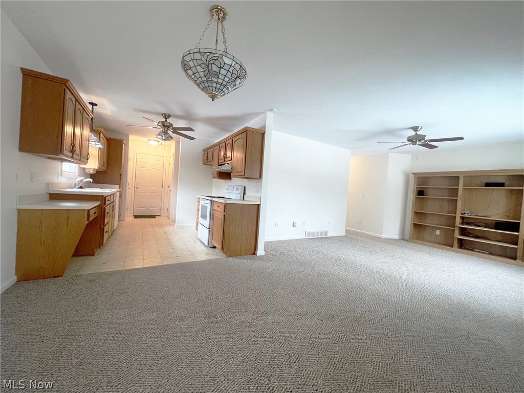 5203 Ridgeland Street Lorain, OH 44055 - Photo 13 of 39 Kitchen with sink, pendant lighting, light tile floors, white range with electric stovetop, and ceiling fan