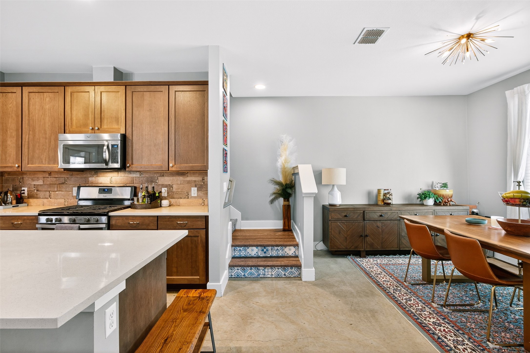 4917 Sunset Trail, Unit A Austin, TX 78745 - Photo 9 of 35 Kitchen with stainless steel appliances, wood finish cabinetry, decorative backsplash, and recessed lighting