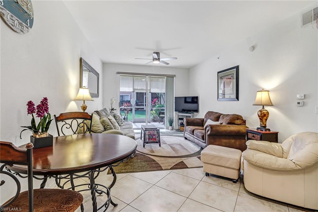20301 Estero Gardens Circle, Unit 104 Estero, FL 33928 - Photo 12 of 43 a living room with furniture flowerpot and a window