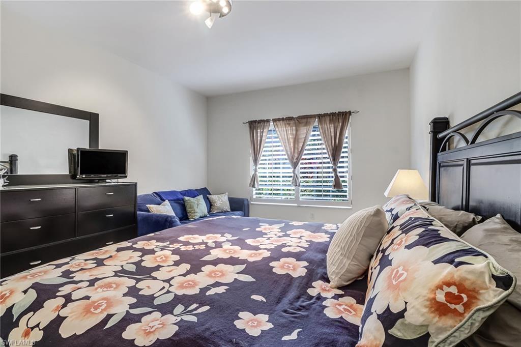 20301 Estero Gardens Circle, Unit 104 Estero, FL 33928 - Photo 17 of 43 a bedroom with a bed and a window